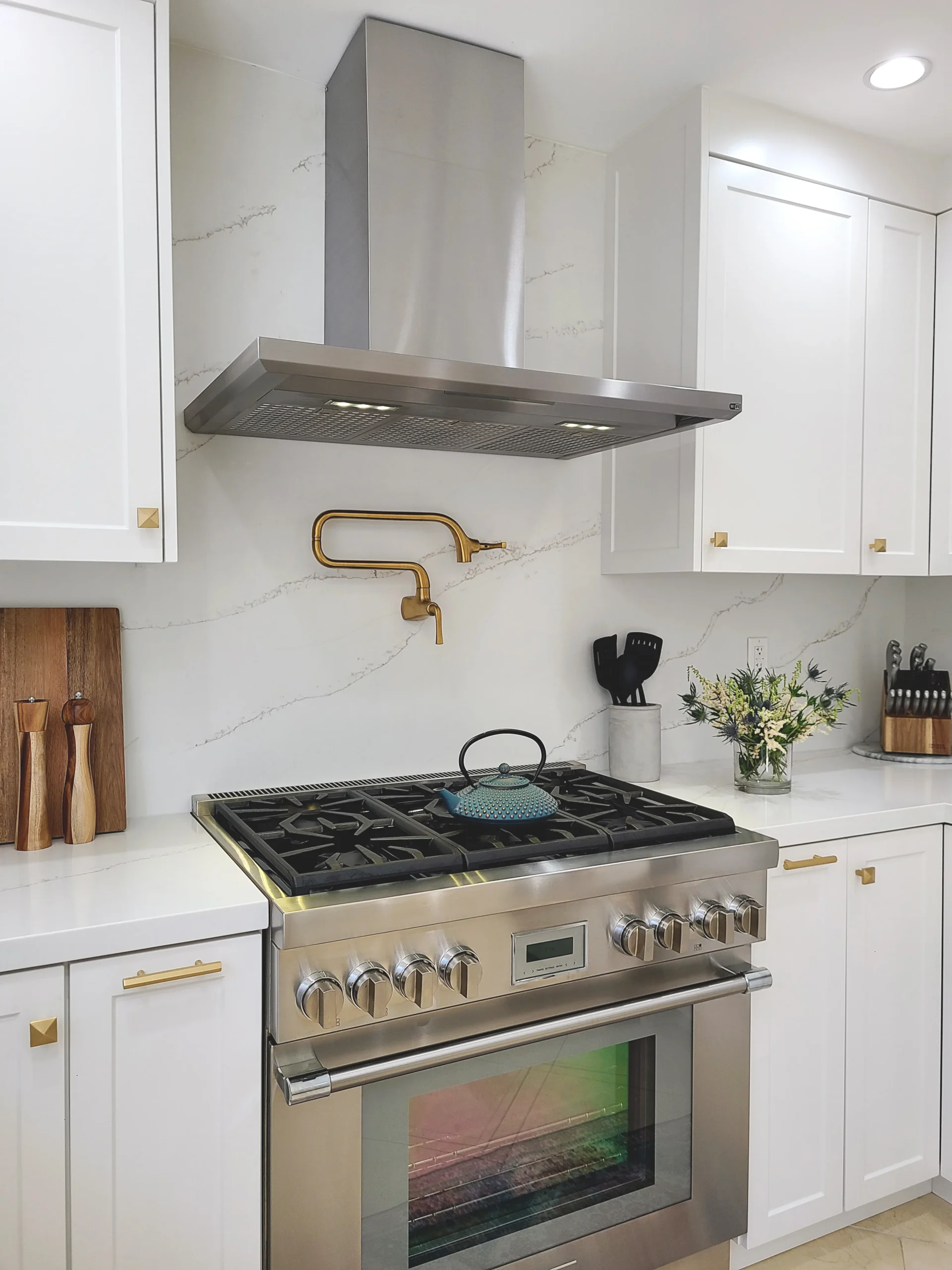 Kitchen Range Wall White Cabinetry Brass Accents, Tarzana CA Interior Conception